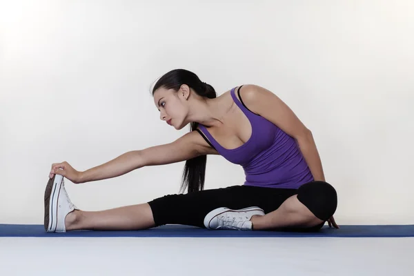 Stretching exercises on a mat — Stock Photo, Image