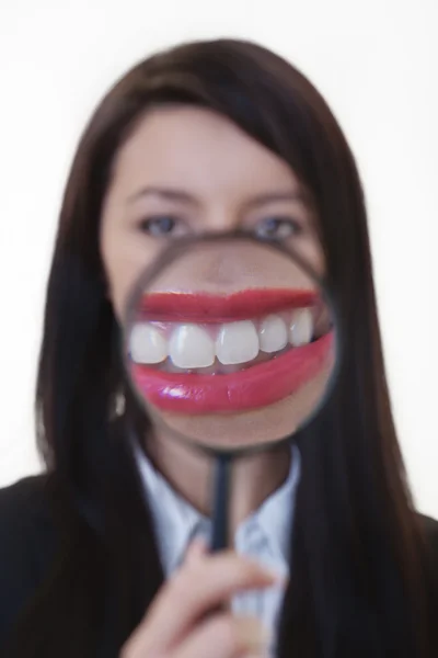 Woman with a magnifying glass — Stock Photo, Image