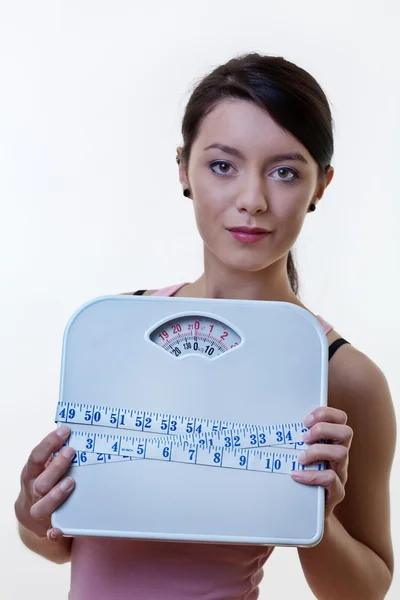 Posing sporty woman with scale and tape measure — Stock Photo, Image