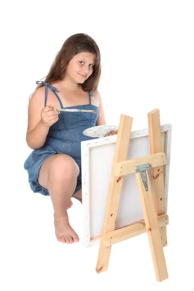 Girl painting a canvas — Stock Photo, Image