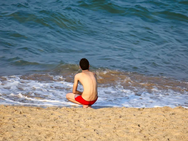 Young man by the sea shore — Stock Photo, Image