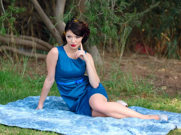 Woman sitting on a blanket — Stock Photo, Image