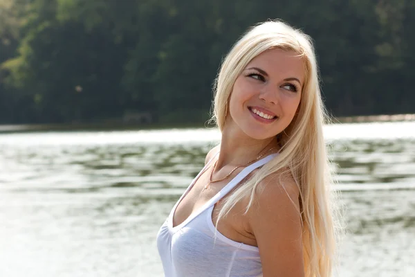 Fiatal vidám szőke lány a tónál — Stock Fotó
