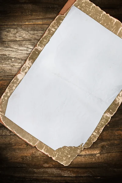 Aged blank paper on a wooden background — Stock Photo, Image