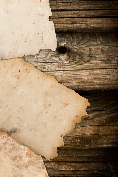 Damaged vintage papers on a wooden background — Stock Photo, Image