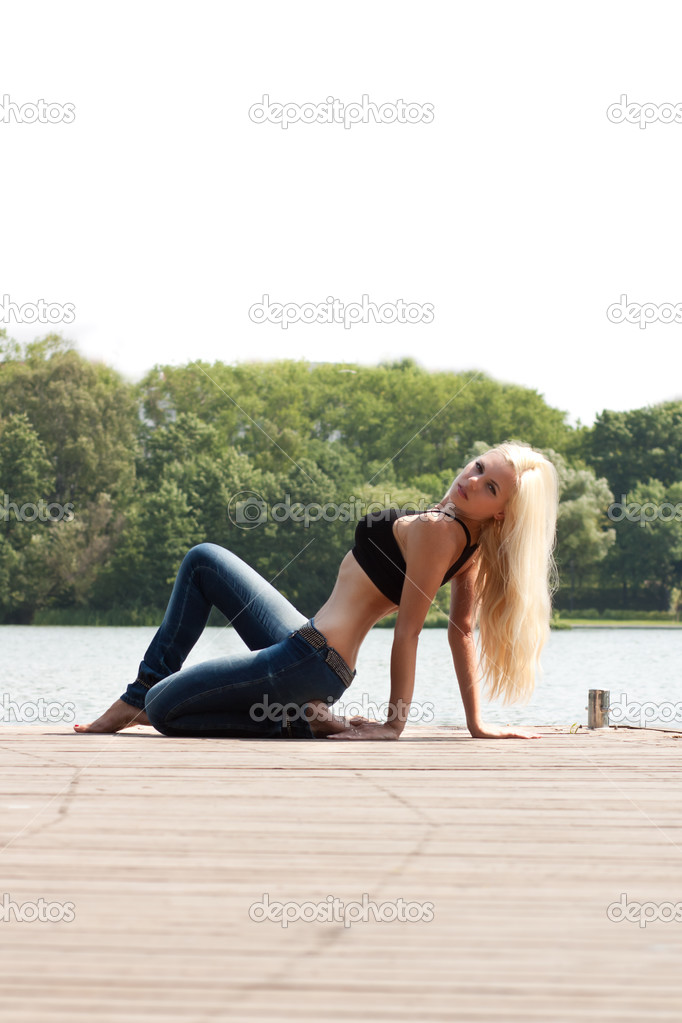 Attractive blond fashion model at the lake