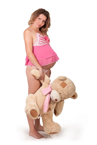 Atractiva chica embarazada con un juguete — Foto de Stock
