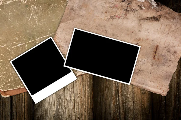 Empty photo frames on a wooden background — Stock Photo, Image