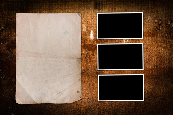 Weathered paper sheet and aged photo frames — Stock Photo, Image