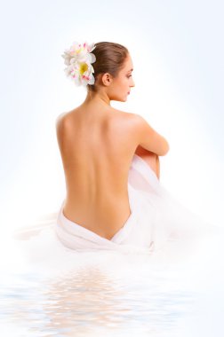 young woman, sitting with a bare back. clipart