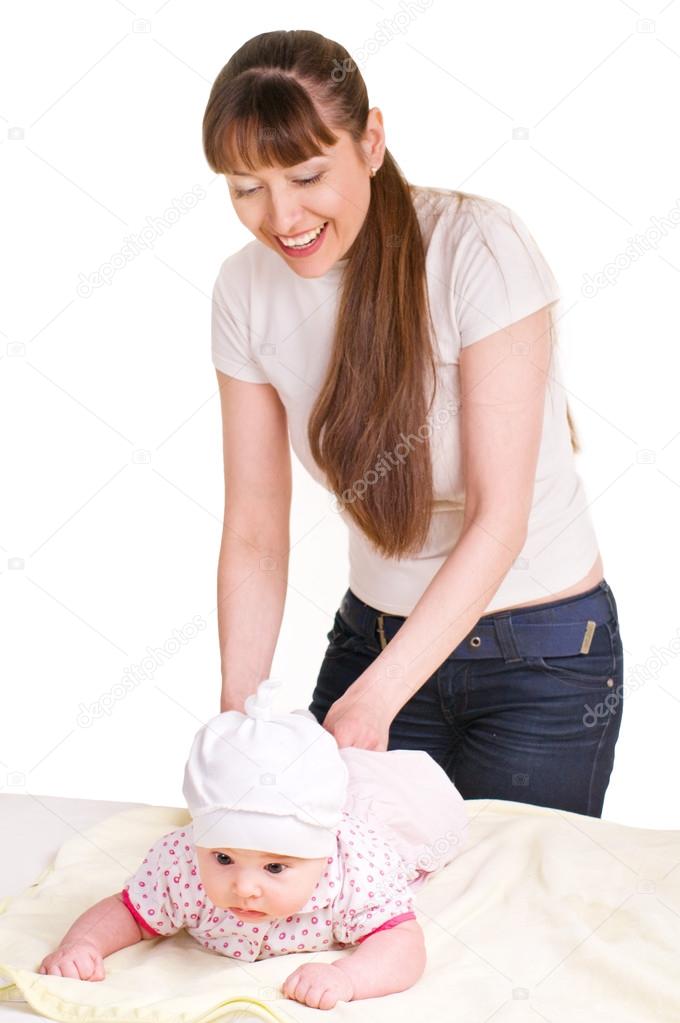 Mother changing babies cloth diaper.