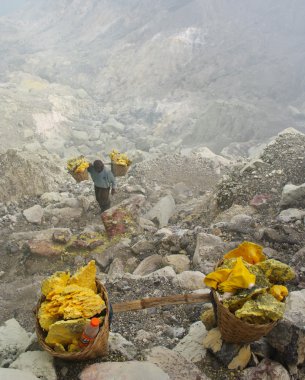 Worker carries sulfur inside crater in Ijen Volcano, Indonesia
