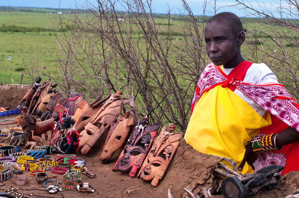 Woman sells traditional souvenirs at Maasai Mara, Kenya.