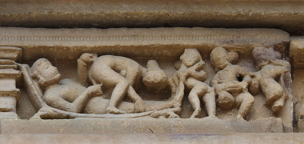 Stone carved erotic bas relief in Hindu temple in Khajuraho, India