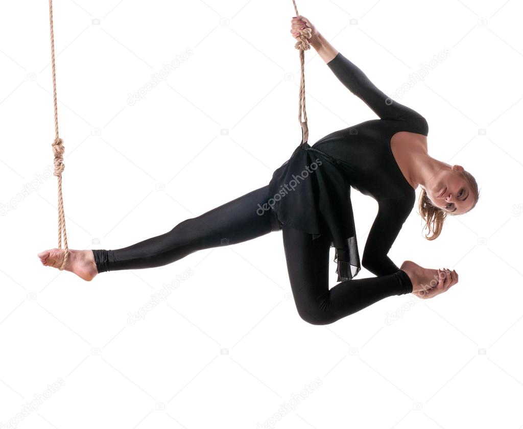 Young woman gymnast on rope on white background
