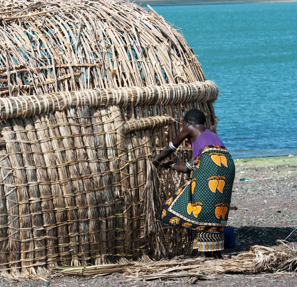 Mulher africana faz cabana tradicional — Fotografia de Stock