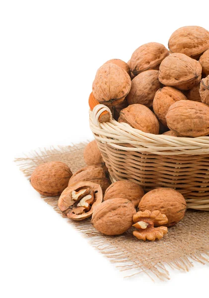 Wicker basket full of walnuts on white background — Stock Photo, Image