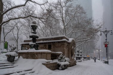 Snow storm in New York City. Manhattan During Nor'easter Blizzard. View of Bryant Park clipart