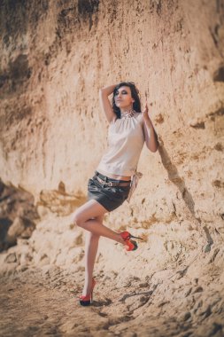 güzel bir kadın rock bir plajda yatan