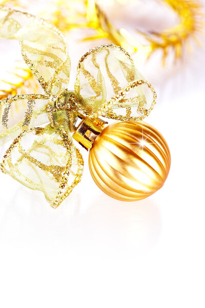 New Year's gold ball with a bow and New Year's tinsel.