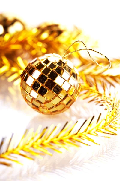 Gold mirror sphere and Christmas tinsel. — Stock Photo, Image