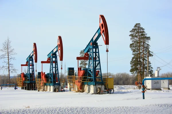 Column labeled "Gas" on the background of oil pump jacks — Stock Photo, Image