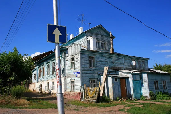 Casa de madeira velha e um sinal de "movimento unilateral " — Fotografia de Stock