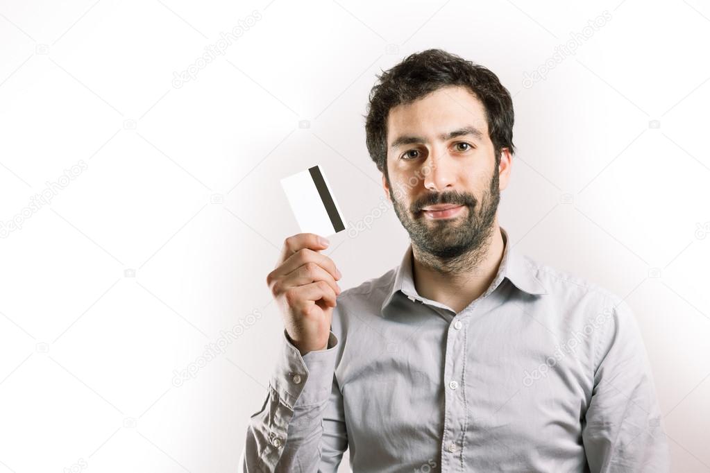 positive young man holding a credit card