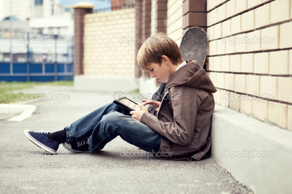 School teen with electronic tablet sitting