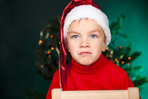 Bad small boy in santa hat — Stock Photo, Image