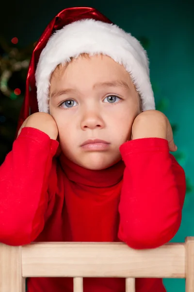 Ledsen liten pojke i santa hatt — Stockfoto