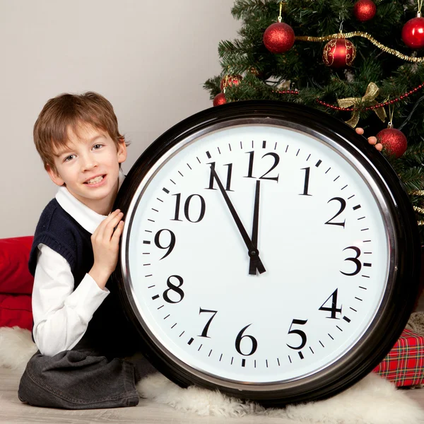 Happy boy hugs Christmas gift — Stock Photo, Image