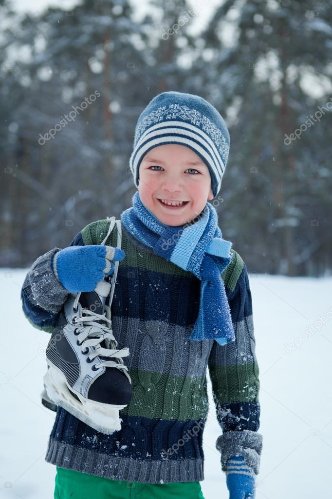 Portrait of boy with skates, winter