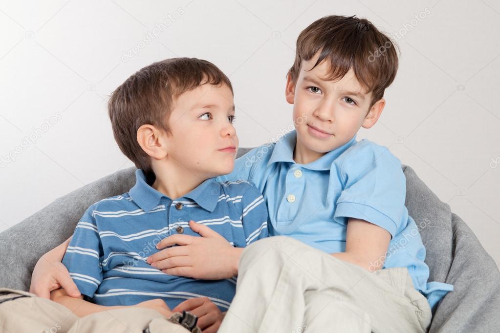 Elder and younger brother sitting on pufe
