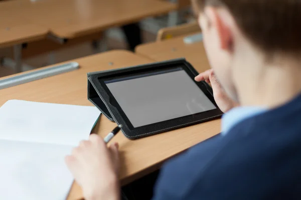 Student and tablet in classroom — Stock Photo, Image