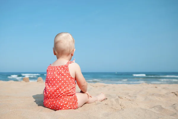 young girl sunbathing on a pebble beach Stock Photo 