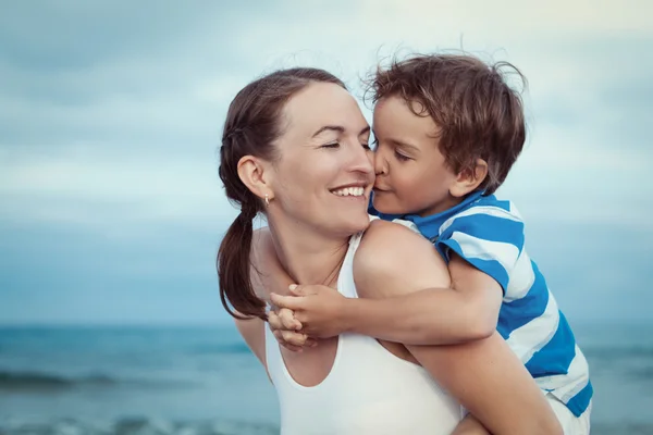 Portrait of happy mother and son at sea