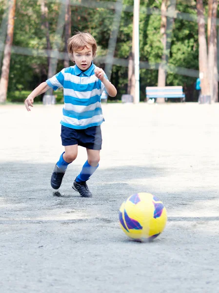 Happy boy playing football — Stock Photo, Image
