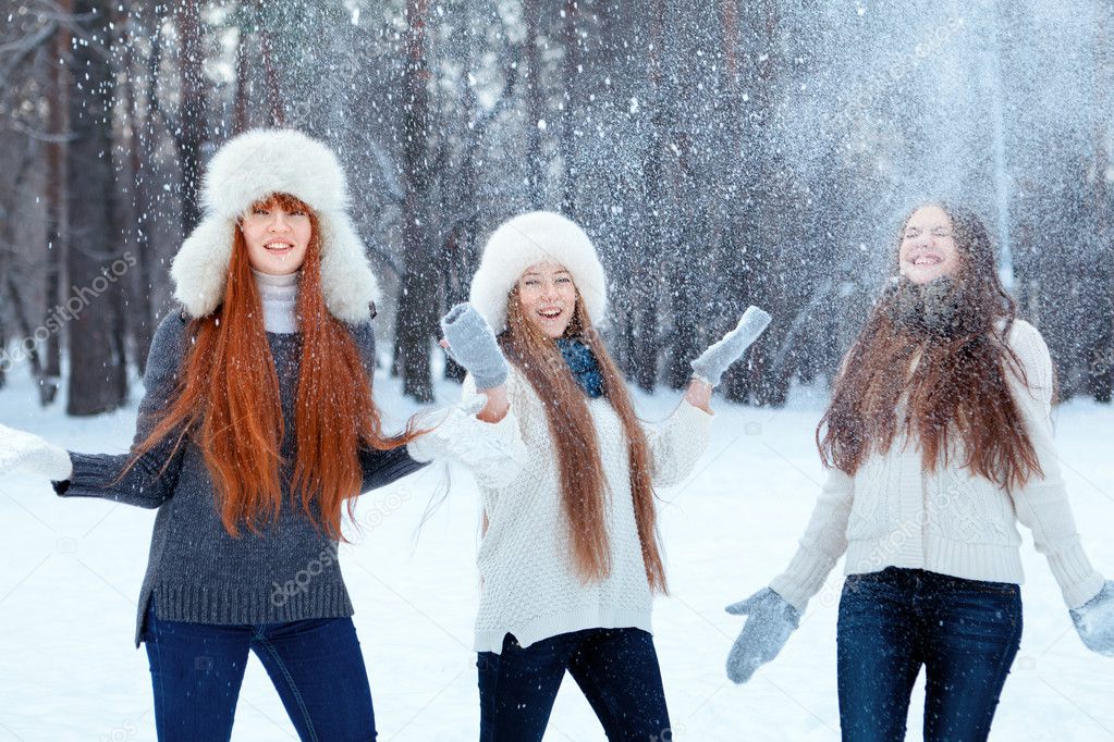 Portrait of three beautiful girls in winter park
