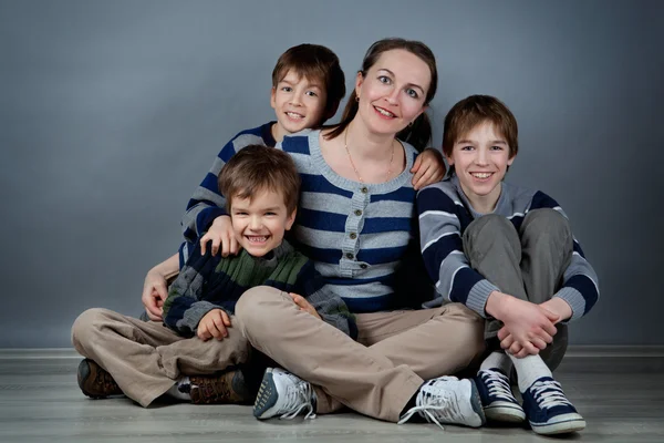 Retrato de mãe feliz e três filhos, estúdio — Fotografia de Stock