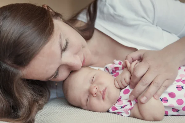 Happy mother hugging little daughter — Stock Photo, Image