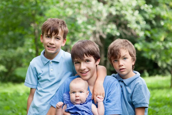 Portrait of three happy brothers and sisters — Stock Photo, Image