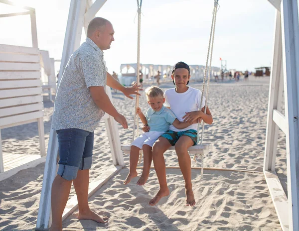 Happy Father Swings His Sons Swing Sea Big Family Vacation — Stock Photo, Image