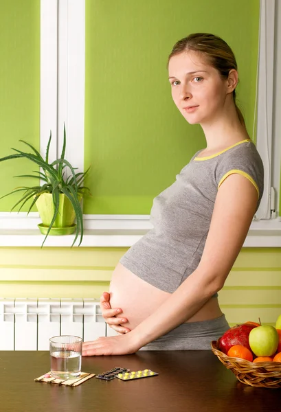 Mulher grávida bonito na cozinha — Fotografia de Stock