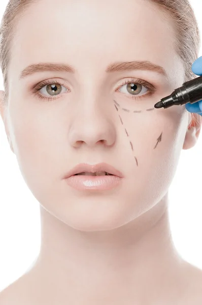 Beautician draw correction lines on woman face — Stock Photo, Image