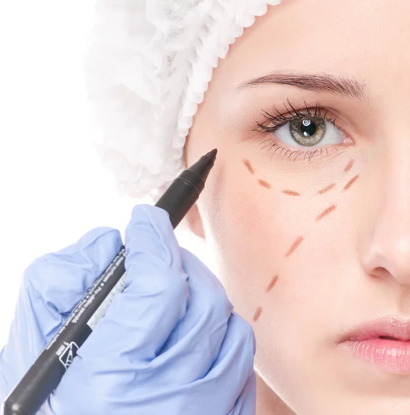 Beautician draw correction lines on woman face — Stock Photo, Image