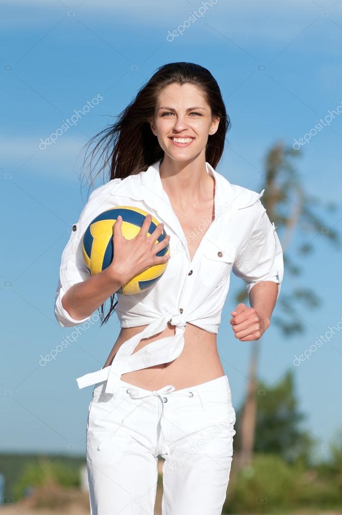 Woman playing volleyball on beach
