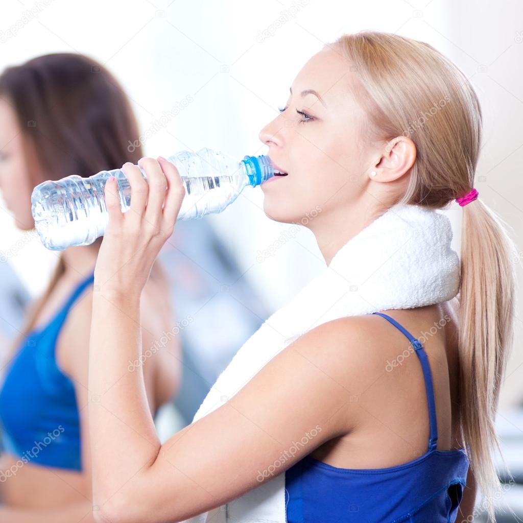 Women drinking water after sports