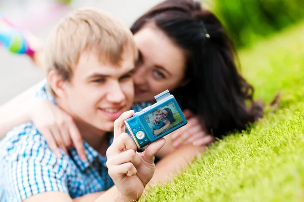 Happy teenage couple taking picture — Stock Photo, Image