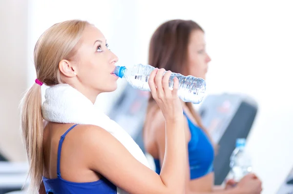 Ženy pitné vody po sportu — Stock fotografie